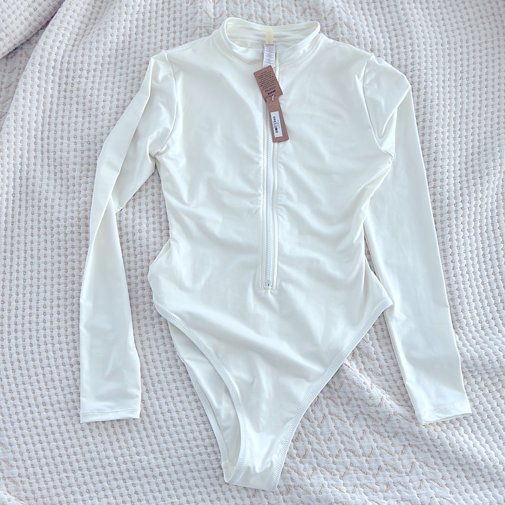 Skims “Swim Zip Front Long Sleeve One Piece” NWT size Medium, White color